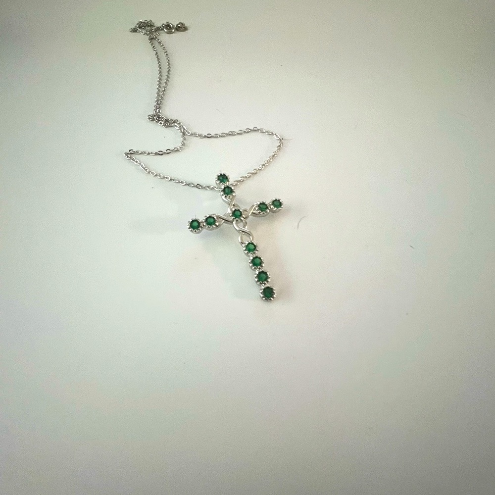 emerald green crystals adorn this large cross necklace